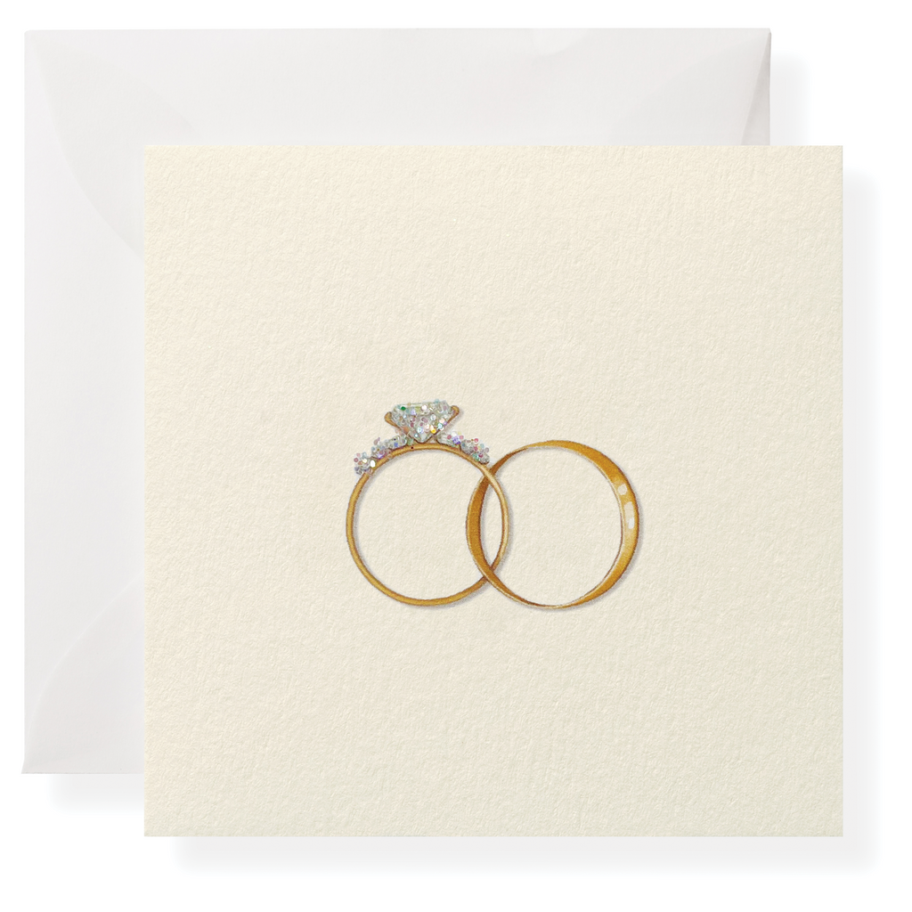 The Karen Adams Just Married Gift Enclosures feature a cream-white card with two gold rings—one with a diamond—set against a white envelope. Their elegant design is ideal for adding charm to any special occasion.