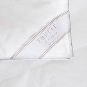 A close-up of a white Frette Cortina Light Density Duvet Insert featuring beige corner detailing and labeled "Made in Italy.