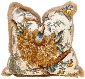 The Le Grand Corail Bleu Pillow with Fringe by Hive Custom Pillows features an ornate floral and leaf pattern in brown, gold, blue, and green on white. Handmade in the USA for a custom look.