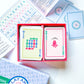 The Play Away Cards Mahjong Playing Cards come in a red box, include an instruction sheet, and feature cards laid out for easy viewing—ideal for beginners wanting quick, enjoyable games.