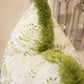 A close-up of the Fern Yellow Pillow by Hive Custom Pillows, featuring a green leafy design and soft fuzzy trim—an ideal choice for anyone seeking a unique, down-filled accent for their space.