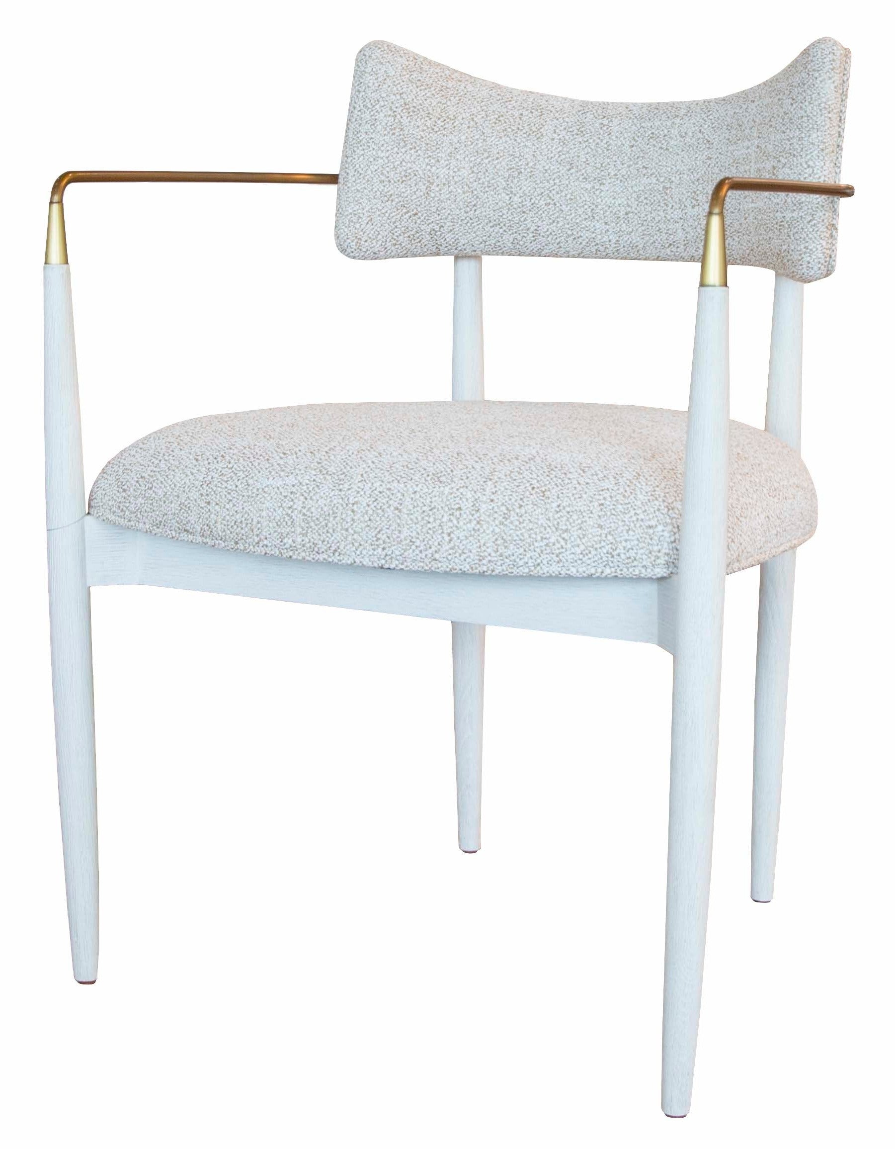 A modern **Durrant Arm Chair** with a white cushioned seat, matching cushioned backrest, thin golden armrests, and slender white legs evokes the elegance of **Mr Brown**.