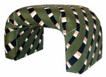A Martini Small Ottoman by Associated Design with a curved structure featuring diagonal patterns in black, white, and pinkish-tan stripes, reminiscent of the bold designs showcased at the Kips Bay Show House.