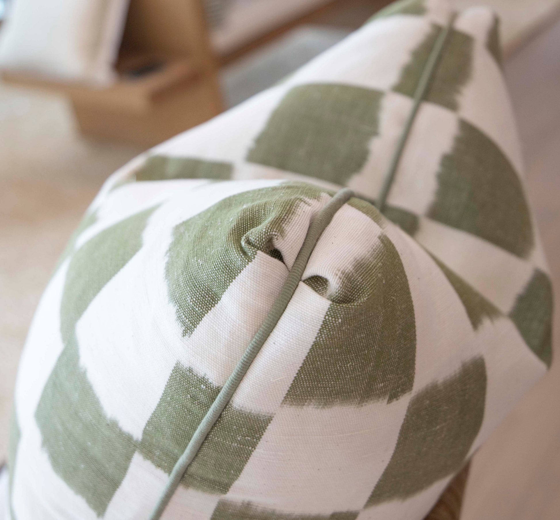 Close-up of the Checkerboard Green Pillow by Hive Custom Pillows, 22" x 22", featuring a green and white geometric checker pattern, textured fabric, and highlighted edge seam.