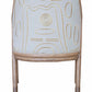 The McGuire Lantana Side Chair, Mushroom features a wooden frame with beige fabric on the backrest, adorned with an embroidered abstract pattern in white and yellow. The furniture dimensions are 21.25"W and 23"D, offering a comfortable yet stylish seating option.