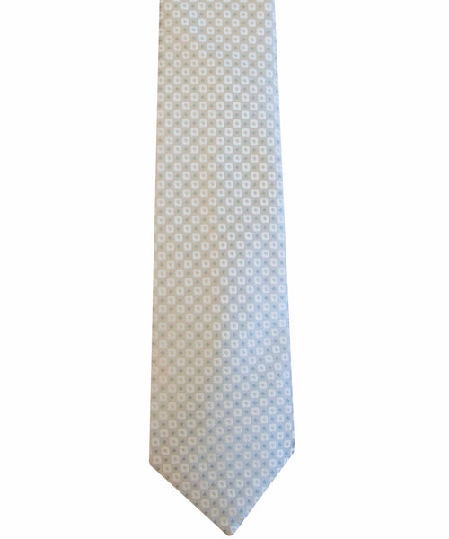 A light blue, handcrafted necktie featuring a small white checkerboard pattern perfect for elevating your personal style is the Robert Jensen Silver Square Dot Tie by Robert Jensen.
