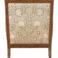 The St. Germain Lounge Chair by McGuire Furniture features a wooden frame and an upholstered backrest in beige and green floral and shell patterns, inspired by 1940s French design for timeless appeal.