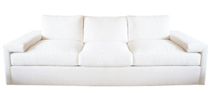 The Denby Sofa by Hickory Chair, featuring a white, three-cushion design with wide armrests, plush back cushions, and a Spring-Down seat cushion, exemplifies European luxury fashion against a plain background.