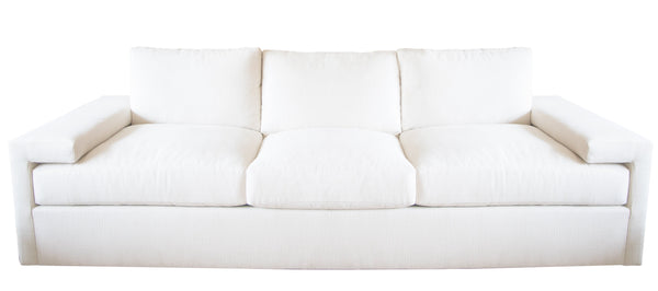 The Denby Sofa by Hickory Chair, featuring a white, three-cushion design with wide armrests, plush back cushions, and a Spring-Down seat cushion, exemplifies European luxury fashion against a plain background.