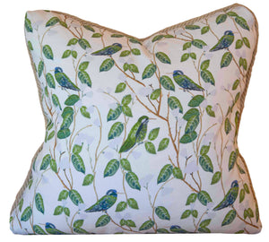 The Hummingbirds White Pillow by Associated Design features green leaves and blue-green birds on a white background. Handmade in the USA, this unique square pillow adds charm to any living space.