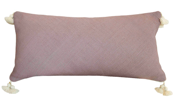 The Royal Bohemian Heather Pillow by Associated Design is a custom-made rectangular pink pillow with a textured surface and tassels at each corner, providing both comfort and style.