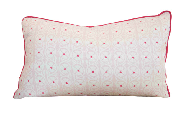 The Pasha Ballet Pillow by Associated Design is a custom rectangular decorative piece featuring circular designs and small red dots, made from premium materials. It has elegant pink piping on the edges and is filled with 100% down for ultimate comfort.