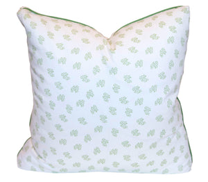 Handmade in the USA, the Dolly Flower Lettuce Green Pillow by Hive Custom Pillows features a white background with a small green leafy design and elegant green piping.