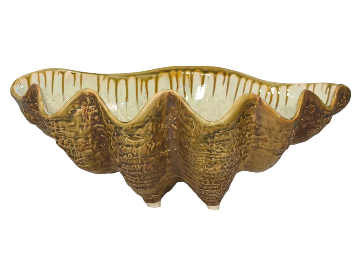 The Large Clam Bowl Collection by AE Ceramics features handmade, clam shell-shaped serving bowls with brownish-gold textured glaze and wavy edges, perfect for bringing coastal charm to your dinnerware.