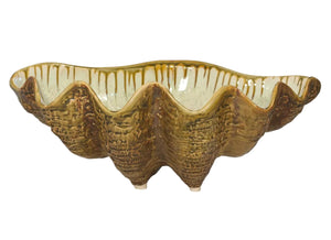 The Large Clam Bowl Collection by AE Ceramics features handmade, clam shell-shaped serving bowls with brownish-gold textured glaze and wavy edges, perfect for bringing coastal charm to your dinnerware.