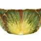 The Anna Weatherley Cabbage Bowl is a hand-painted ceramic bowl featuring green and yellow lettuce leaf shapes with brown accents, inspired by Hungarian porcelain.
