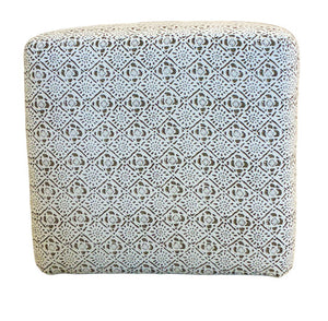 The Lee Industries Cube Ottoman features casters for easy mobility and showcases a white and black geometric pattern, combining versatile style with convenience.