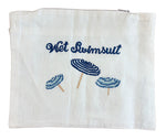The Haute Home Wet Swimsuit Bag, Blue Beach Umbrellas features white fabric, blue embroidered "Wet Swimsuit" text, and three blue beach umbrella designs—ideal for storing swimwear after a beach day.