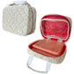 Beige and white patterned zippered carrying case from the Stephanie Johnson Paros Coconut Travel Collection, shown open to reveal a pink Mae Mini Pouch inside a red-lined interior. Includes handles and a clear plastic pouch.
