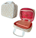 Beige and white patterned zippered carrying case from the Stephanie Johnson Paros Coconut Travel Collection, shown open to reveal a pink Mae Mini Pouch inside a red-lined interior. Includes handles and a clear plastic pouch.