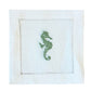 The Coastal Cocktail Napkin Set by Pink House Mustique features white linen napkins with a decorative cutwork border and an embroidered green seahorse, perfect for bringing coastal charm to your table.