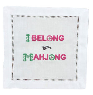 The August Morgan "I Belong to Mahjong" Cocktail Napkin is a cotton napkin with classic hemstitching and features green and pink embroidered text reading "I BELONG TO MAHJONG.