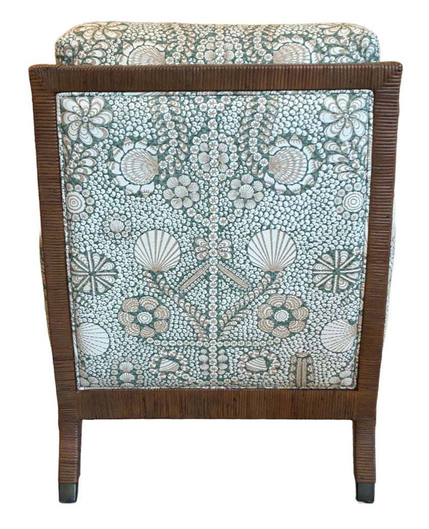 The St. Germain Lounge Chair by McGuire Furniture features a wooden frame and elegant green and white upholstery with a floral and shell pattern, embodying classic French style in its luxurious design.