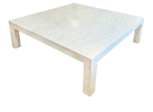 The Bojay Bone Inlay Cocktail Table features a square, modern white design with a smooth top and four thick legs—perfect for adding elegant artistry to stylish living rooms. Photographed on a white background.