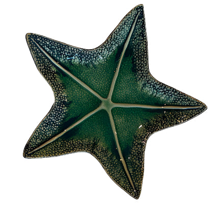 The Van Cleve Collection Green Starfish Dish Collection features star-shaped dishes with textured edges and a glossy deep green glaze, crafted with artisanal detail.