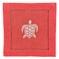 The Coastal Cocktail Napkin Set by Pink House Mustique features square red linen napkins with a white embroidered turtle design and decorative coastal-inspired stitching.