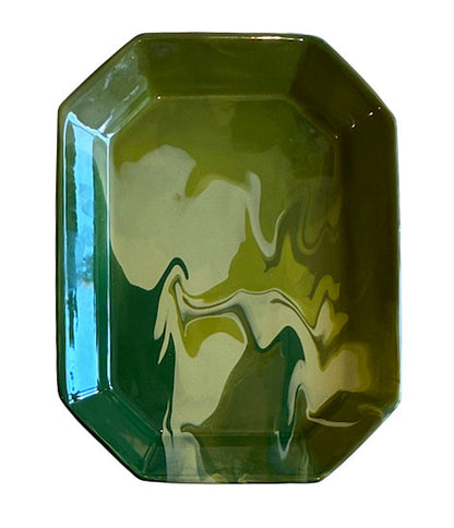 The Geode Tray Collection by Paul Schneider Ceramics features rectangular ceramic trays with rounded edges and a glossy marbled swirl pattern in green and yellow for a colorful accent.