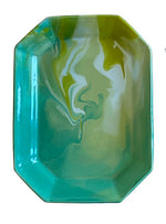 The Geode Tray Collection by Paul Schneider Ceramics features a rectangular ceramic tray with beveled corners and a glossy marbled swirl in green, yellow, and turquoise for a vibrant accent.