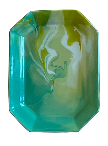 The Geode Tray Collection by Paul Schneider Ceramics features a rectangular ceramic tray with beveled corners and a glossy marbled swirl in green, yellow, and turquoise for a vibrant accent.