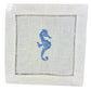 Add coastal charm to your table with the Coastal Cocktail Napkin Set by Pink House Mustique—white linen napkins featuring a blue embroidered seahorse and decorative cutwork border.