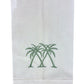 White linen hand towel from Pink House Mustique’s Coastal Linen Hand Towel Collection, featuring three embroidered green palm trees near the bottom center for a breezy coastal charm.