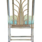 The Sea Cliff Side Chair, Amala Vert by Associated Design features an acrylic and bamboo frame with a custom green Amala Ikat seat cushion, shown from the back.