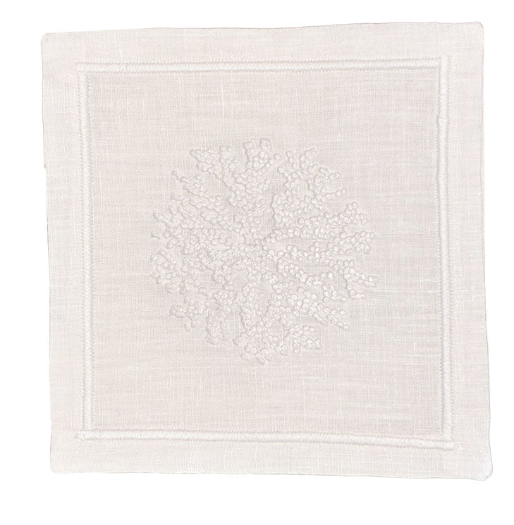The Haute Home Sea Sponge Coaster Set features white fabric squares, hand embroidered with a coral-like design and stitched borders—perfect for pairing with napkins or using as an elegant set of 4 for sophisticated table settings.