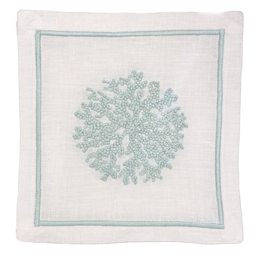 White linen napkin features a light blue embroidered coral design and matching stitched border. Pair it with Haute Home’s Sea Sponge Coaster Set for an elegant table setting.