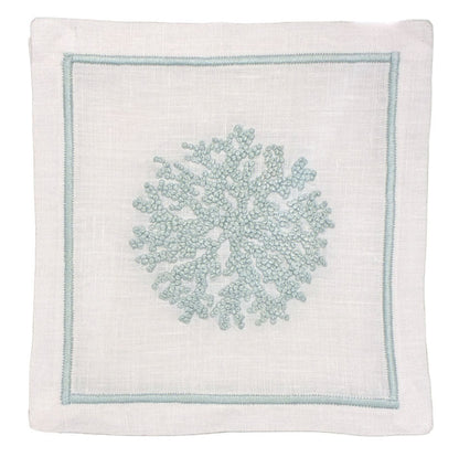 White linen napkin features a light blue embroidered coral design and matching stitched border. Pair it with Haute Home’s Sea Sponge Coaster Set for an elegant table setting.