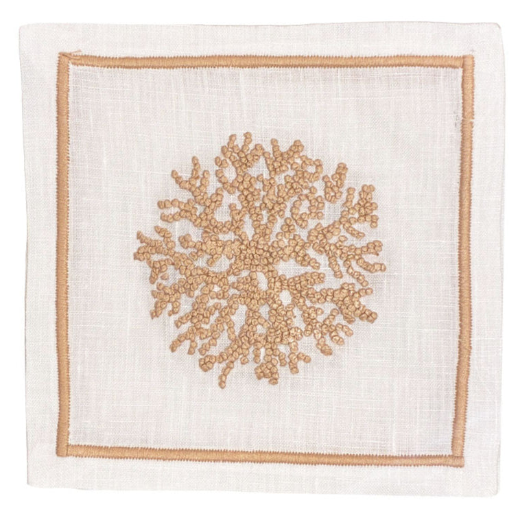 The Sea Sponge Coaster Set by Haute Home features white linen coasters with a central beige hand-embroidered coral motif and a delicate light brown border.
