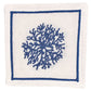 The Haute Home Sea Sponge Coaster Set features white linen coasters with a blue hand-embroidered coral motif at the center, outlined by a blue rectangular border.