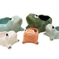 The Ceramic Frog Collection by Jean Roger Paris features five planters in green, blue, white, and orange, displayed together against a white background.