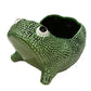 The Ceramic Frog Collection by Jean Roger Paris features a green ceramic planter shaped like the brand’s iconic frog, with an open back cavity for holding small plants or items.