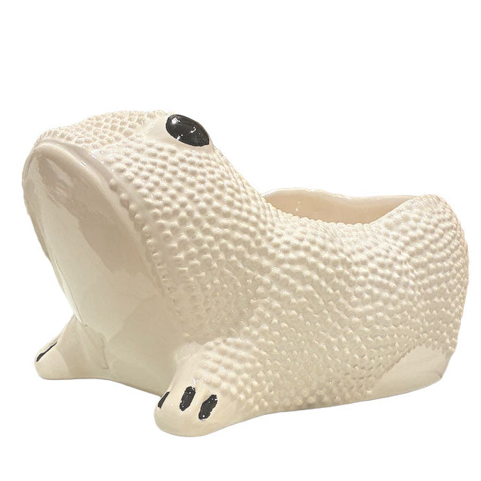 A white ceramic planter from the Jean Roger Paris Ceramic Frog Collection features textured skin and black painted eyes and toes, inspired by Jean Roger’s iconic frog designs.
