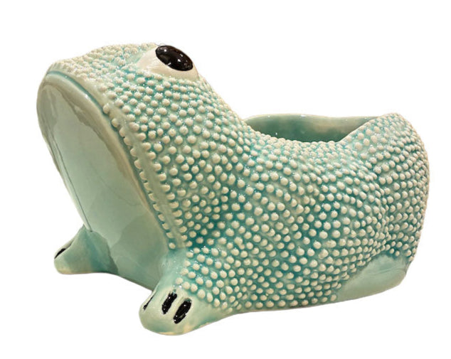 From the Jean Roger Paris Ceramic Frog Collection, this textured light blue ceramic planter is shaped like a frog with black and white eyes and black markings on its front feet.