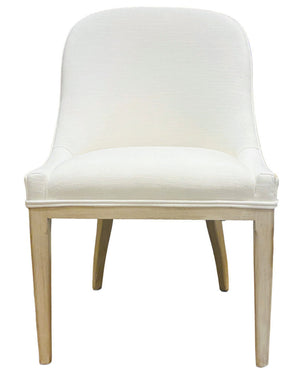 The Maurice Dining Chair by Sherrill/Mr & Mrs Howard features a white upholstered seat, curved backrest, and light wooden legs, creating a stylish and comfortable dining option for any space.