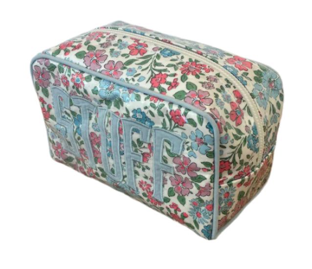 The Walker Valentine Milan Cosmetic Case is a rectangular zippered pouch with a floral pattern and “STUFF” on the side—ideal for carrying your beauty essentials when traveling.