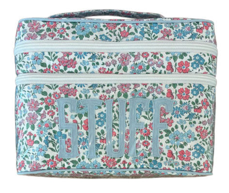 The Walton Travel Case by Walker Valentine is a rectangular organizer with a floral pattern and "STUFF" in bold on the front. Double zippers open to spacious compartments for essentials.