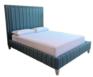 The Sorrento Navy Square Queen Bed by Lee Industries features a tall, upholstered headboard and frame in blue patterned Sorrento Navy fabric, paired with a white mattress and two white pillows.