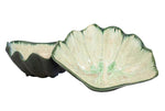 Two Medium Clam Bowls from AE Ceramics, with scalloped edges and a green and cream glaze, are displayed overlapping—a perfect touch of coastal style for your table.